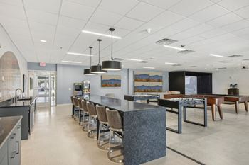 the lobby of a restaurant with a long counter and chairs
